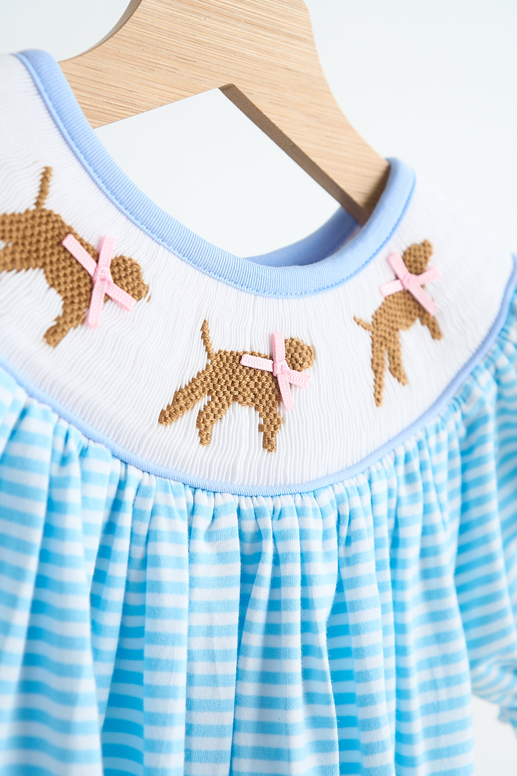 Blue puppy hand smocked girl romper